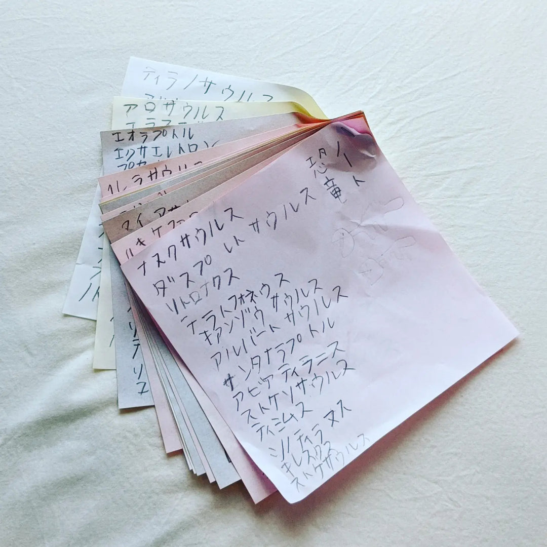 A dinosaur notebook out of origami paper.